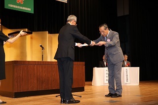 表彰状を贈呈する名和連絡協議会会長と代表受領する桑原安井地区連合自治会前会長